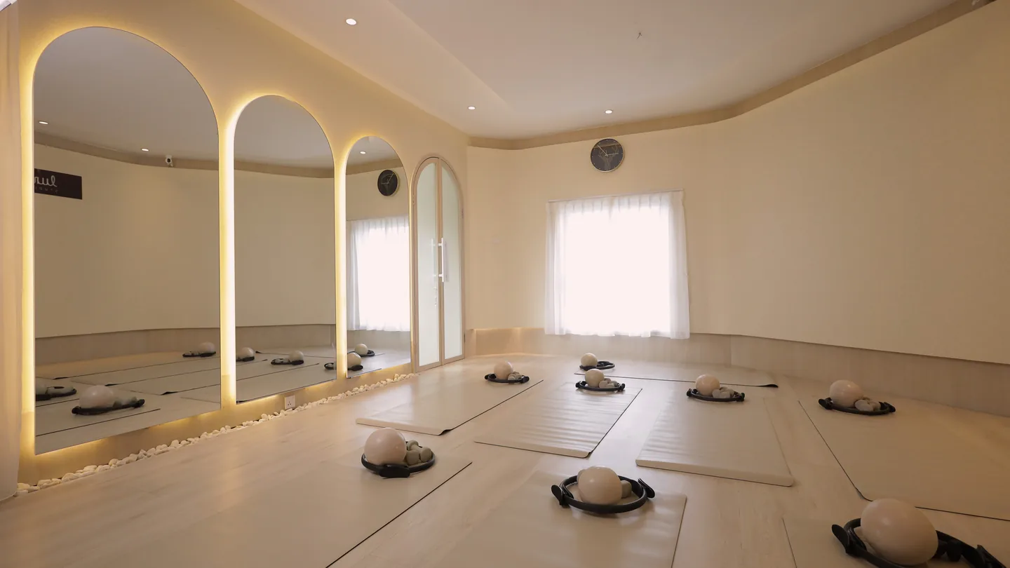 The mat studio, with arched doorways and mats laid out on pale wood floors